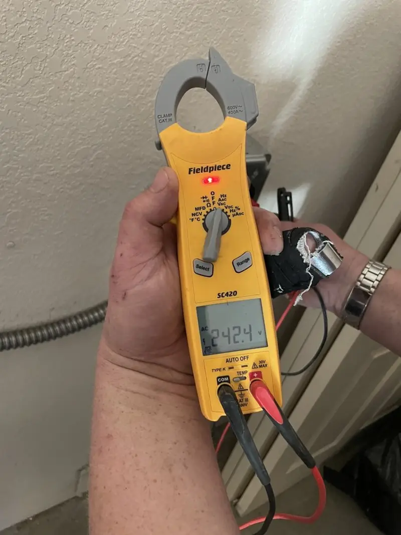 Voltage testing with clamp meter during Recessed Lighting Installation in Boonville